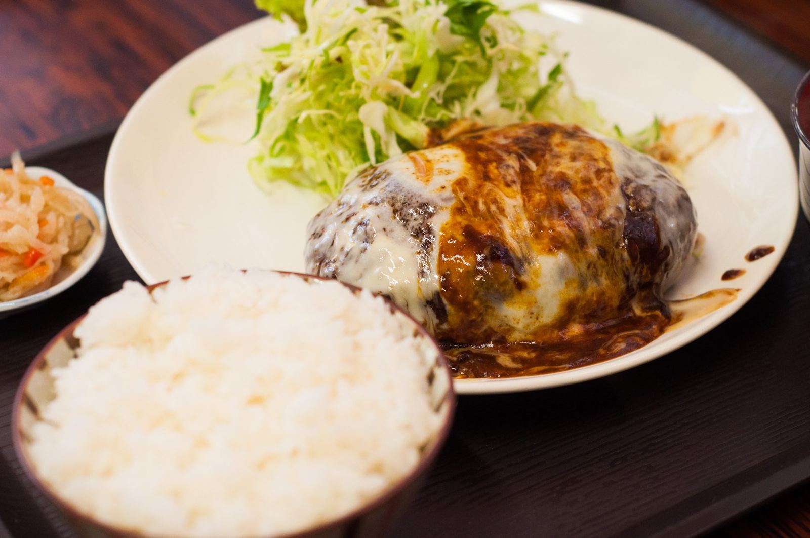 デミグラスソースとチーズをかけたメンチカツの定食。ご飯と小鉢